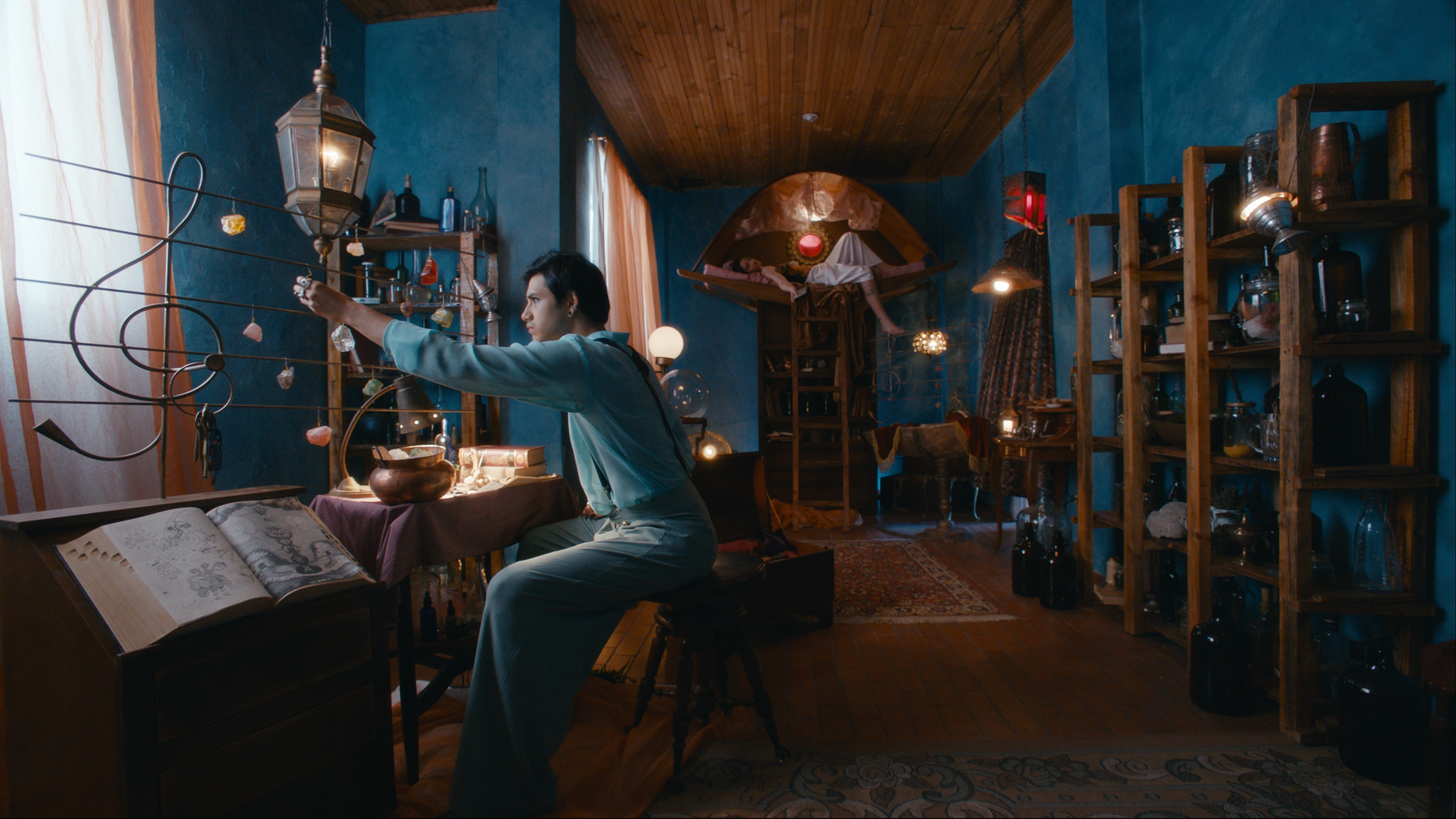 Dante among instruments and shelves in the blue room